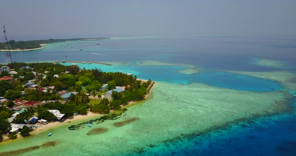 Tropical overhead copy space shot of a white sandy paradise beach and aqua blue water background in 