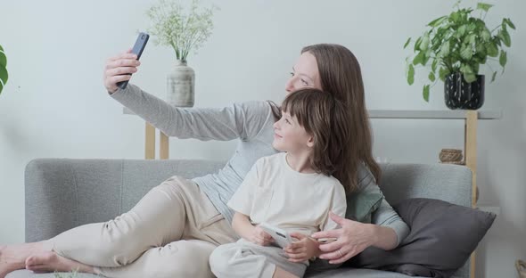 Modern Woman Babysitter and Kid Boy Posing Hugging Together Taking Photo Use Smartphone