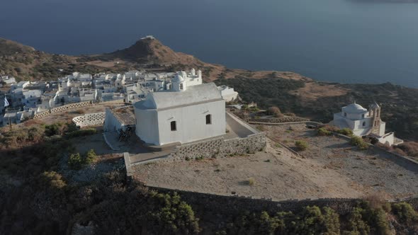 Church on Top of the Hill with Greek Flag Waving in Wind Aerial Perspective