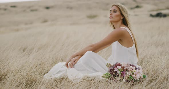 Beautiful woman relaxing in golden fields