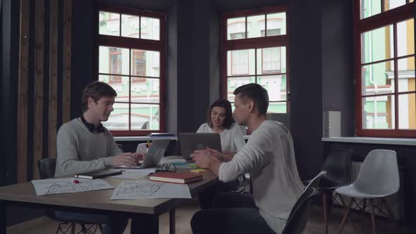 Co Workers Sitting and Talking in Startup Agency.