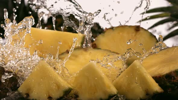 Slow Motion Shot of Pineapple and Water Splashing Through Pineapple Slices