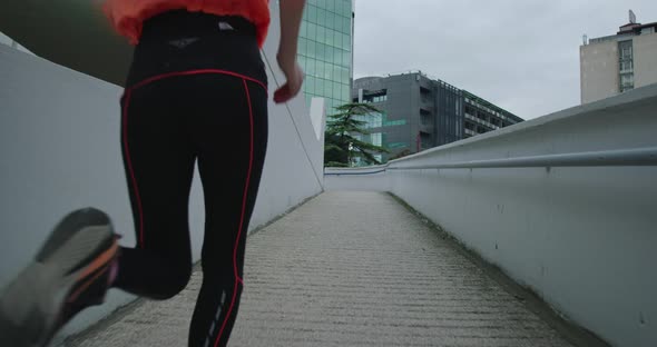 Sporty Young Woman in Sweatshirt Running in the Night Town