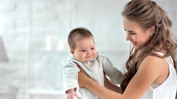 Happy Woman Playing with Cute Child Smiling Having Fun Together Surrounded By Natural Light