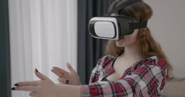 Young Girl in VR Glasses at Home