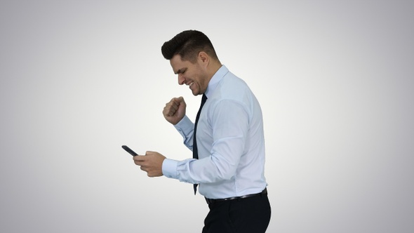 Happy business man walking in frame using mobile phone