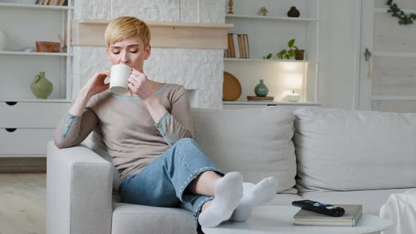 Serene Carefree Young Woman Drinking Warm Tea at Home Pleasant Leisure Day