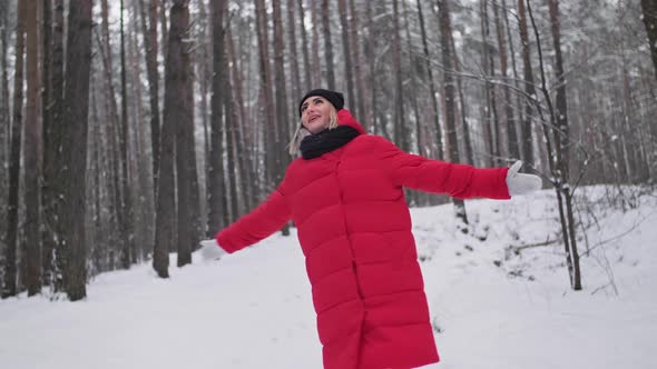 Cheerful Young Woman Enjoying Winter in Forest
