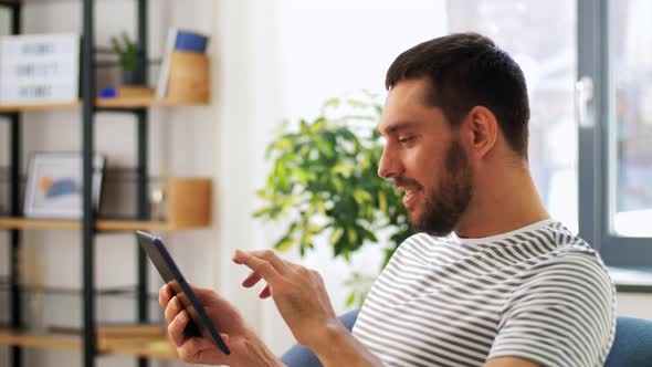 Smiling Man with Tablet Pc Computer at Home