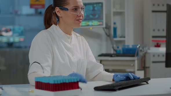 Woman Working in Chemistry Laboratory with Computer