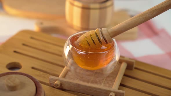 Honey Spoon in Wooden Bowl Close Up Shot