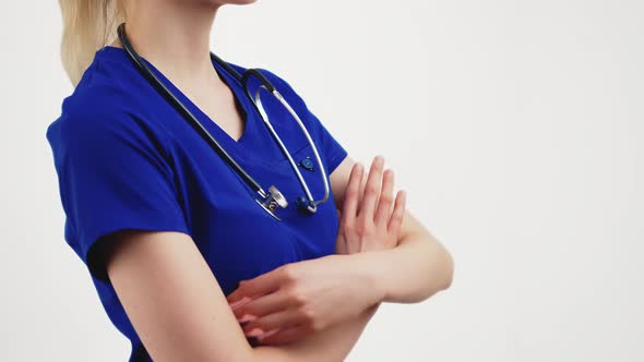 Blonde Beautiful Nurse Stands Folding Her Hands  Isolated White Background Copyspace