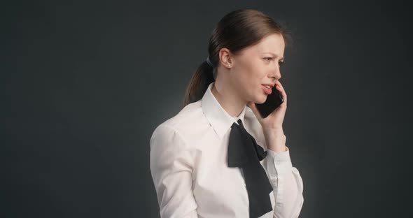 Furious Woman in Business Suit Emotionally Scolds Her Interlocutor on the Phone and Gesticulates