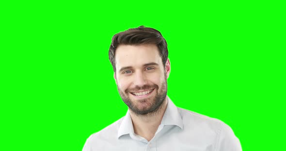 Smiling man standing against green screen