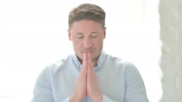 Portrait of Man Praying with Fingers Crossed
