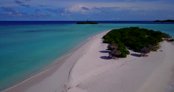 Wide angle overhead travel shot of a paradise sunny white sand beach and blue ocean background in hi