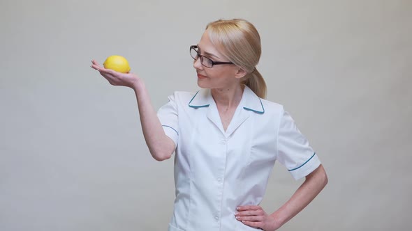 Nutritionist Doctor Healthy Lifestyle Concept - Holding Organic Lemon Fruit