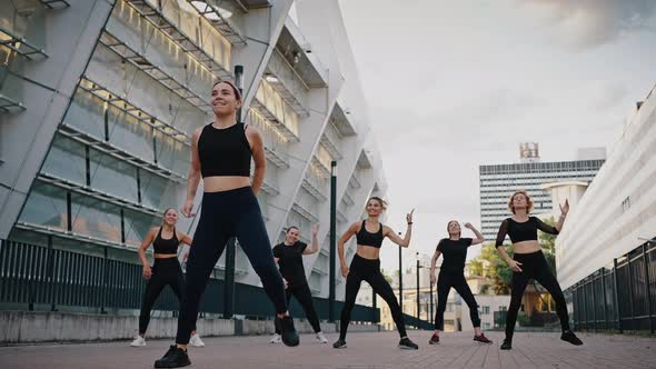 Group of Women Performing Zumba Dances in City Street Fitness