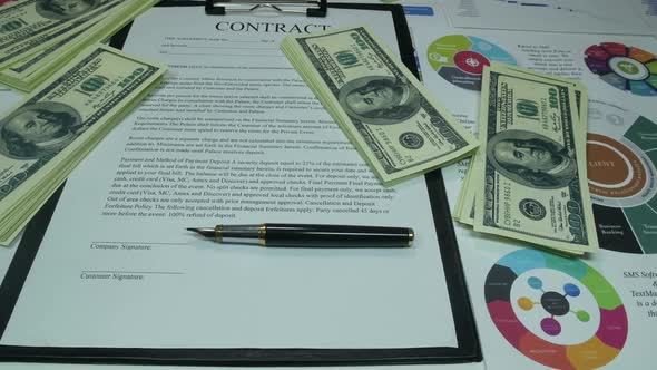 Financial Business Contract And Money On The Table In The Office Of The Company