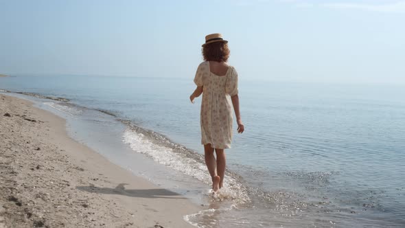 Cheerful Girl Running Ocean Waves Back View