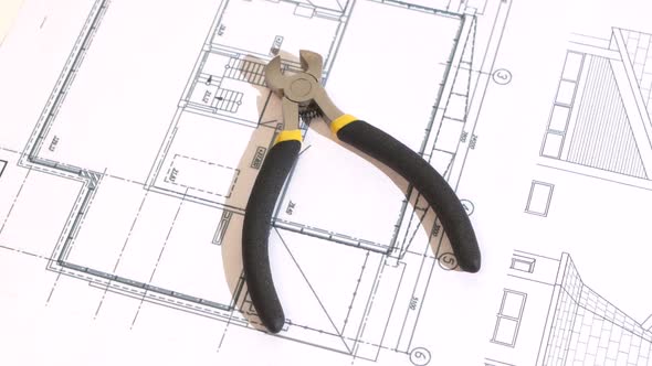 Wire Cutters with Yellow, Gray Handle on Building Plan, Scheme, Rotation