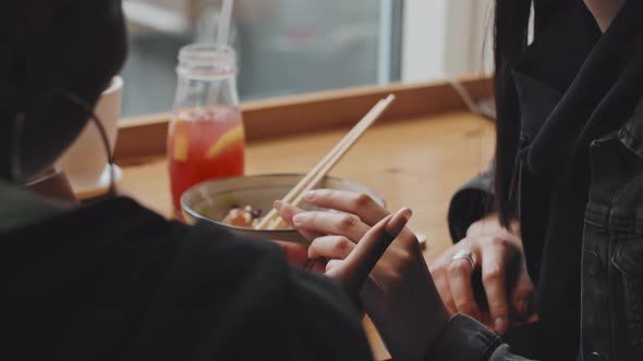Close Up of Woman Holding Girlfriends Hand in Cafe