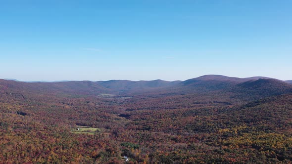 An aerial tracking shot of the Trout Run Valley in West Virginia. Autumn colors are seen on the tree