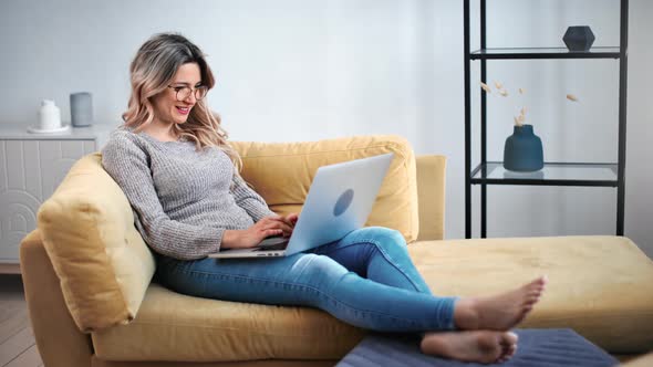 Happy Barefoot Freelancer Woman Sitting Couch Working Remotely Laptop