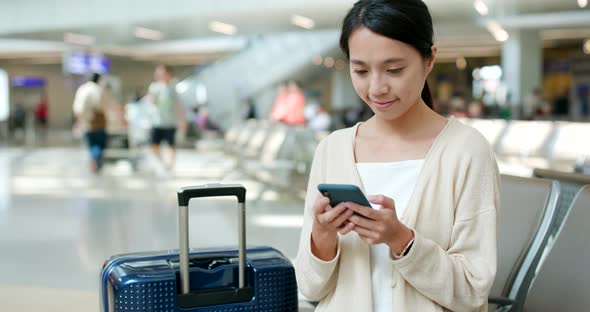 Woman use of smart phone in the airport