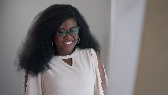 Portrait of Smiling Joyful Young African American Woman Dancing in Slow Motion Admiring Reflection