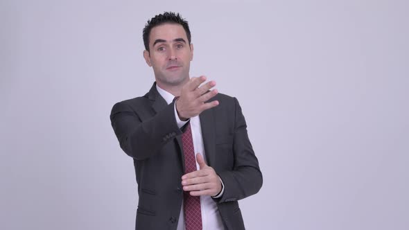 Handsome Businessman Talking Against White Background