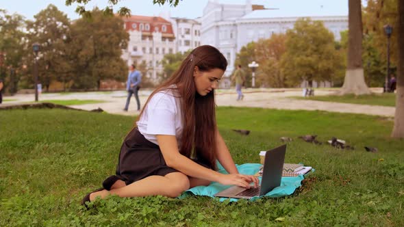 Attractive Girl Using Computer Outdoors