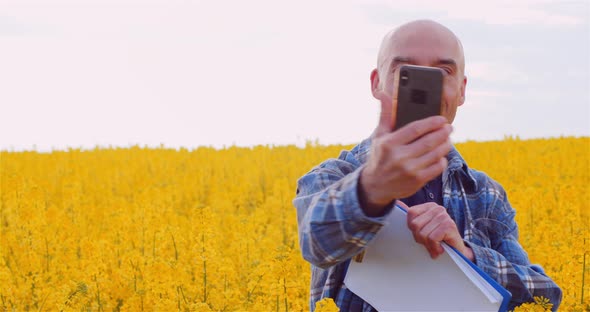 Confident Male Agronomist Communicating Through Smartphone