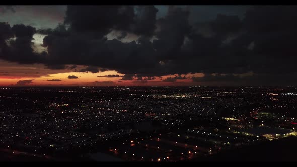 Twilight sunset with an awesome colored sky while flying over small town.