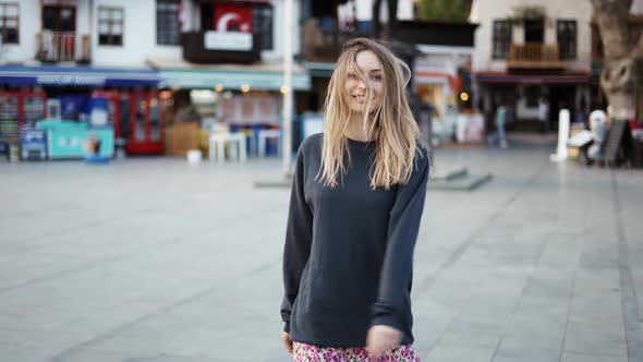 Blonde Woman Dance Outdoors Turn Around to Express Positive Emotions