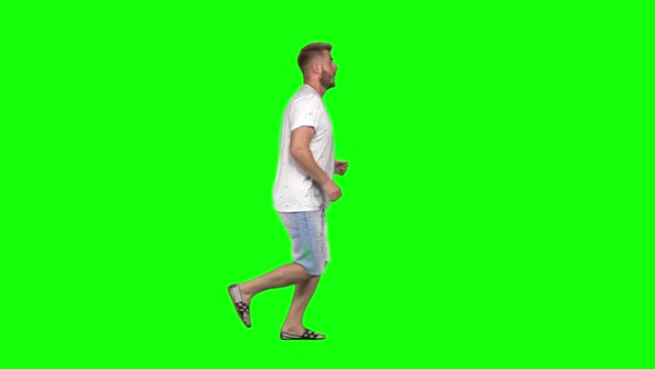 Bearded Guy Calmly Is Running on Green Screen Background. Chroma Key. Profile View. Slow Motion