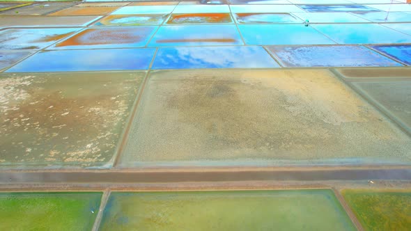 Aerial view flying over a beautiful colorful natural sea salt pond