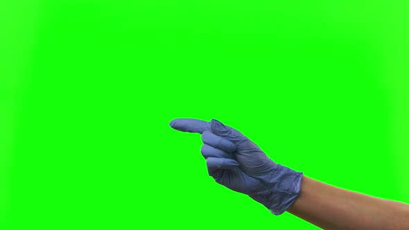 Doctors Female Hand in Blue Glove Raises One Index Finger Waving It From Side To Side in Gesture