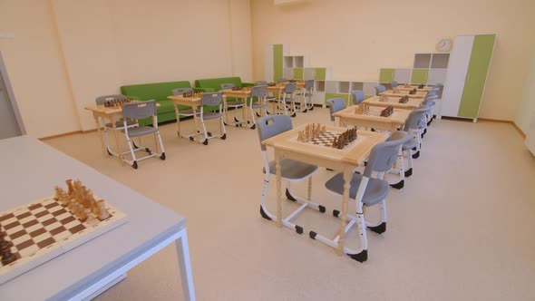 Sets of Chessmen on Tables in Classroom at Educative Center