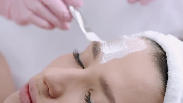 Cropped View of Beautician Putting Facial Mask on Face