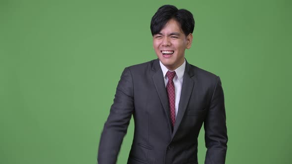 Young Handsome Asian Businessman Laughing