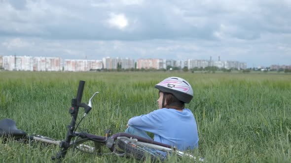 A child in a bicycle helmet in the countryside. 