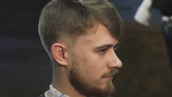 Close Up of a Handsome Yougn Man Getting a Haircut at the Barbershop