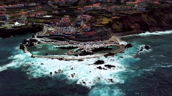 AERIAL LANDSCAPE ORBIT SHOT OF PORTO MONIZ LAVA BEACH IN MADEIRA ISLAND, PORTUGAL