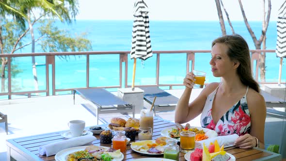 Female Tourist Have Buffet Breakfast at Outdoor Restaurant in Tropical Hotel Turquoise Sea