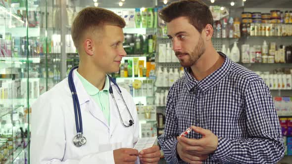 Doctor Consulting Patient About Pills