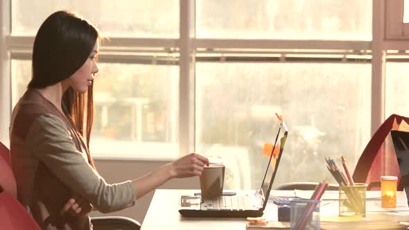 Girl Has a Good Idea and Type It on Laptop Notebook