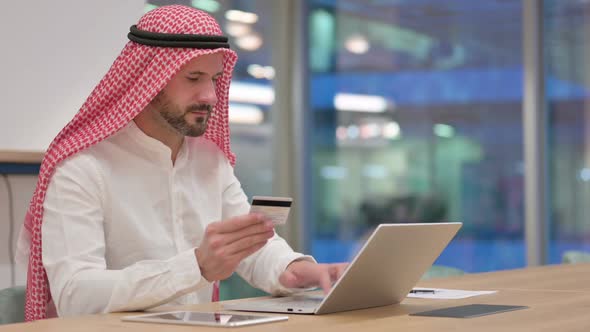 Online Payment Success on Laptop for Arab Businessman