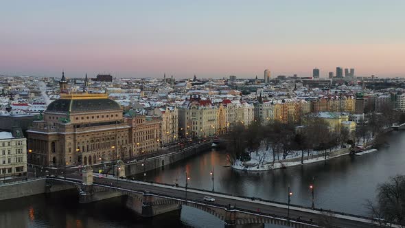 Drone aerial view of Prague, Czech Republic. Snow capped buildings, Vltava river Legion bridge and t