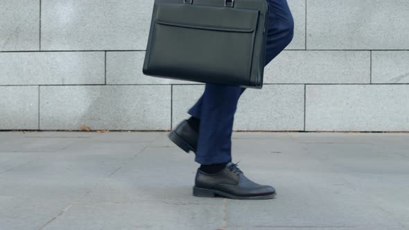 Businessman Legs Walking on City Street. Worker with Briefcase Going for Work